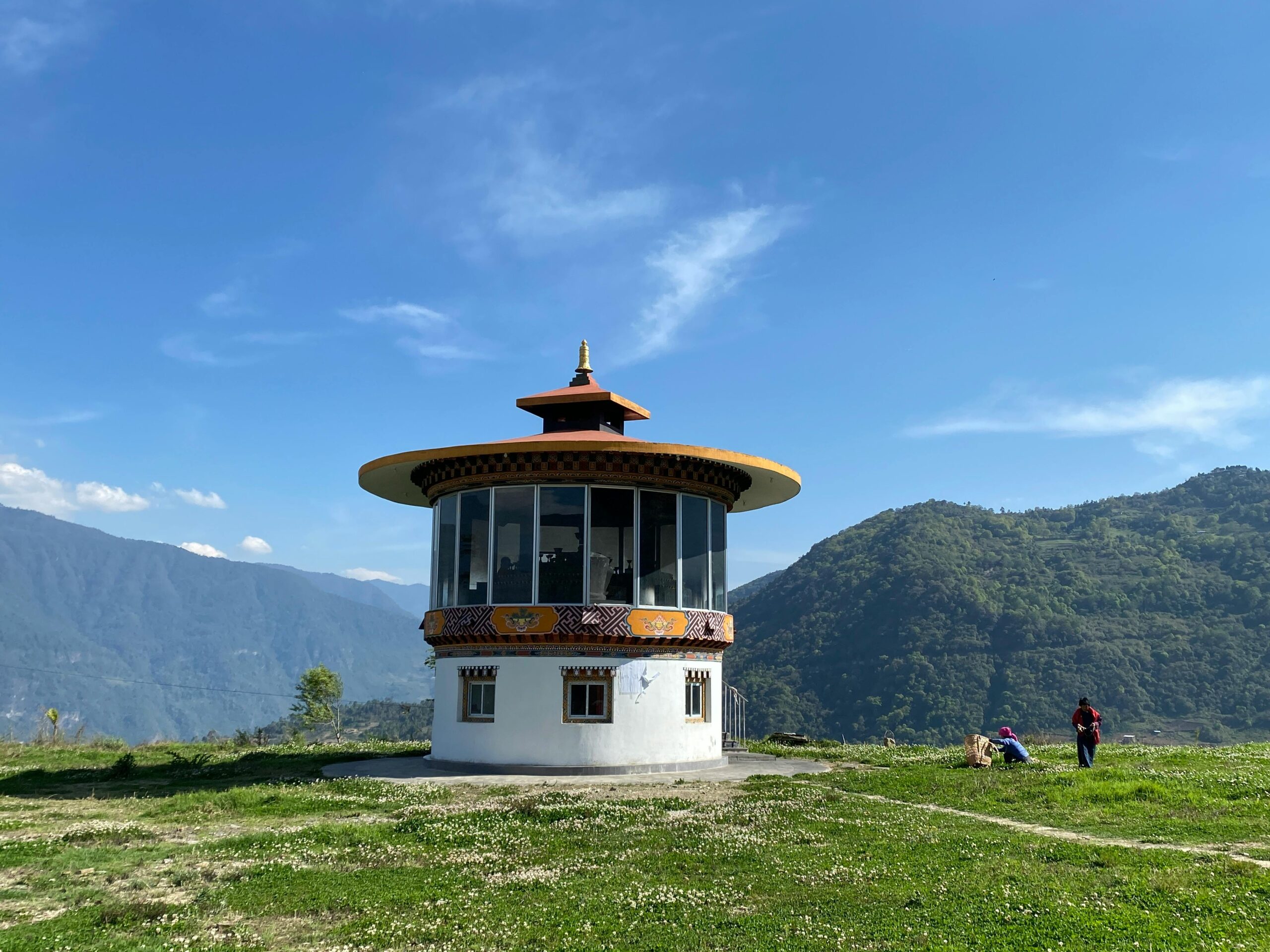 Round pavilion with mountains and blue sky, ideal for travel and architecture themes.